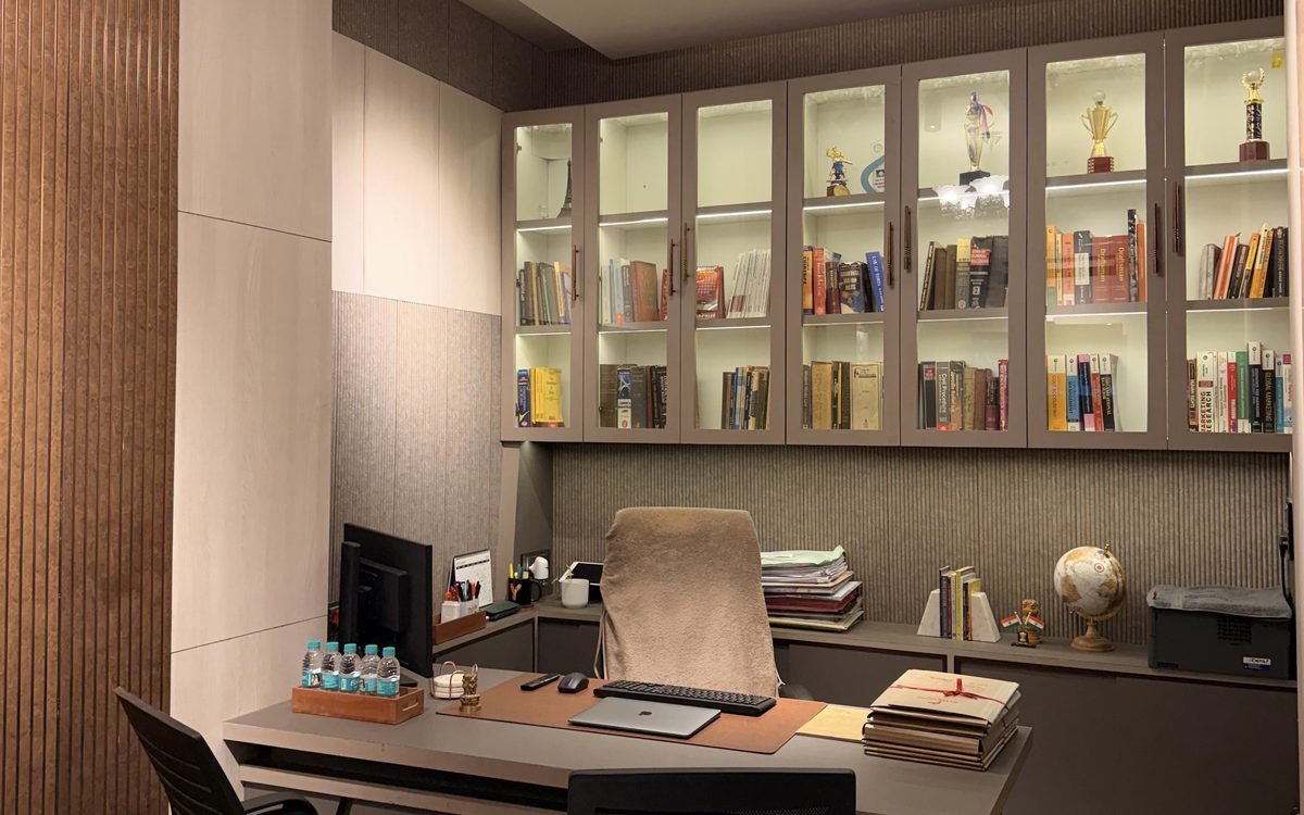 The chambers of Civil Law Firm: a glass-fronted bookcase of law reports and textbooks above the working desk